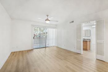 A room with a sliding glass door and a ceiling fan. at The Viridian Apartments, Arizona, 85250